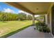 Covered patio with a view of a large backyard featuring green grass and privacy bamboo at 1597 Katie Cv, Sanford, FL 32771