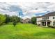 Expansive backyard featuring lush green grass, mature trees, and a charming outdoor space at 1597 Katie Cv, Sanford, FL 32771