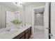 Bathroom with a double sink vanity, large mirror, and an open shower at 1597 Katie Cv, Sanford, FL 32771