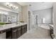 Modern bathroom with a double sink vanity, soaking tub, and separate walk-in shower at 1597 Katie Cv, Sanford, FL 32771