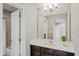 Bathroom with a single sink vanity, large mirror, and an open shower at 1597 Katie Cv, Sanford, FL 32771