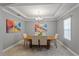 Formal dining room featuring tray ceilings, chandelier and neutral color palette at 1597 Katie Cv, Sanford, FL 32771
