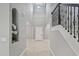 Grand foyer with soaring ceilings, decorative staircase and elegant tile flooring at 1597 Katie Cv, Sanford, FL 32771
