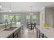 Bright kitchen with large windows, quartz counters, and a center island with a breakfast bar at 1597 Katie Cv, Sanford, FL 32771