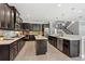 Spacious kitchen with a large island, dark cabinets and stainless steel appliances at 1597 Katie Cv, Sanford, FL 32771
