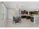 A spacious kitchen featuring dark cabinets, stainless appliances, and an island with counter seating at 1597 Katie Cv, Sanford, FL 32771