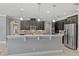 Open kitchen featuring dark cabinetry, stainless steel appliances, and a breakfast bar at 1597 Katie Cv, Sanford, FL 32771