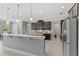 Open kitchen featuring dark cabinetry, stainless steel appliances, and a breakfast bar at 1597 Katie Cv, Sanford, FL 32771
