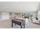 Bright living room with comfortable seating, a large TV, and a foosball table at 1597 Katie Cv, Sanford, FL 32771