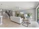 Open-concept living room with staircase, neutral color palette, and ample space for entertaining at 1597 Katie Cv, Sanford, FL 32771