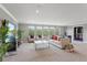 Bright living room with large windows, comfortable seating, and a foosball table at 1597 Katie Cv, Sanford, FL 32771