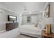 Serene main bedroom featuring a tray ceiling, plush carpet, and a large window overlooking the backyard at 1597 Katie Cv, Sanford, FL 32771