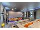 Well-lit home theater room with reclining sofa, projector screen, and surround sound system at 1597 Katie Cv, Sanford, FL 32771