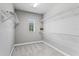 Spacious walk-in closet featuring built-in shelving and a window for natural light at 1597 Katie Cv, Sanford, FL 32771