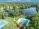 Aerial view of the lake with the community pool, picnic area, and tennis courts at 172 Clear Lake Cir, Sanford, FL 32773