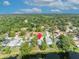 Aerial view showcases home nestled in a lush, wooded neighborhood with waterfront access at 172 Clear Lake Cir, Sanford, FL 32773
