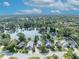 Expansive aerial view showcasing a neighborhood with houses that overlook a large lake surrounded by lush greenery at 172 Clear Lake Cir, Sanford, FL 32773