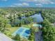 Aerial view of a community swimming pool, tennis courts and picnic area by the lake at 172 Clear Lake Cir, Sanford, FL 32773