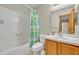 Cozy bathroom with a tiled shower-tub combination and a decorative cactus shower curtain at 172 Clear Lake Cir, Sanford, FL 32773