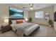 Staged bedroom with bed, bedside tables and lamps at 172 Clear Lake Cir, Sanford, FL 32773