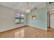 Neutral dining room with chandelier, wood-look floors, and large windows at 172 Clear Lake Cir, Sanford, FL 32773
