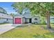 Attractive one-story house featuring a bright pink garage door, verdant lawn, and mature landscaping at 172 Clear Lake Cir, Sanford, FL 32773