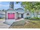 Charming single-story house with a well-maintained lawn, a garage, and mature trees shading the property at 172 Clear Lake Cir, Sanford, FL 32773