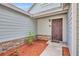 Inviting front entrance with a decorative security door, brick accents, and colorful landscaping at 172 Clear Lake Cir, Sanford, FL 32773