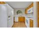 Efficient kitchen with wood cabinets, white appliances, and a bright window at 172 Clear Lake Cir, Sanford, FL 32773