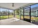 Spacious sunroom with ceiling fan, screened windows, and views of the backyard and waterfront at 172 Clear Lake Cir, Sanford, FL 32773
