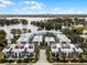 Aerial view of modern townhomes by the lake with contemporary design and lush landscaping, showcasing community layout at 1760 Mondrian Cir, Winter Park, FL 32789