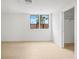 Bright bedroom with light wood floors and a window view of palm trees at 1760 Mondrian Cir, Winter Park, FL 32789