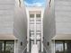 Modern townhome exterior featuring clean lines, striking windows, and symmetrical design, with a welcoming entrance at 1760 Mondrian Cir, Winter Park, FL 32789