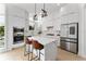 Modern kitchen features stainless steel appliances, waterfall island, and white cabinetry at 1760 Mondrian Cir, Winter Park, FL 32789