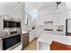 Contemporary kitchen featuring built-in stainless steel appliances, white cabinets, and marble backsplash at 1760 Mondrian Cir, Winter Park, FL 32789