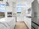 Bright kitchen features modern cabinets, stainless appliances, marble countertops, and a large window at 1760 Mondrian Cir, Winter Park, FL 32789