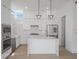 Modern kitchen features white cabinets, stainless steel appliances, and marble countertops and backsplash at 1760 Mondrian Cir, Winter Park, FL 32789