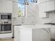 Modern kitchen with white cabinets, quartz countertops, and stainless-steel appliances at 1760 Mondrian Cir, Winter Park, FL 32789