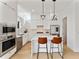 Bright kitchen with stainless appliances, white cabinets and center island with barstool seating at 1760 Mondrian Cir, Winter Park, FL 32789
