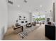 Spacious living room with large windows, modern furniture, and a contemporary rug at 1760 Mondrian Cir, Winter Park, FL 32789