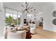 Stylish open-concept living area with modern decor, floor-to-ceiling windows, and sleek, white kitchen at 1760 Mondrian Cir, Winter Park, FL 32789