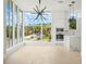 Bright living space with a modern light fixture, large windows, and an open kitchen at 1760 Mondrian Cir, Winter Park, FL 32789