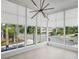 Bright living room features a modern light fixture and expansive corner windows at 1760 Mondrian Cir, Winter Park, FL 32789