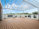 Spacious rooftop deck featuring modern pergola, clear glass railings, and wooden flooring for relaxing and entertaining at 1760 Mondrian Cir, Winter Park, FL 32789