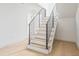 Modern staircase featuring wood stairs and black metal railings at 1760 Mondrian Cir, Winter Park, FL 32789