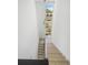 Modern staircase with wooden steps leading to a skylight at 1760 Mondrian Cir, Winter Park, FL 32789