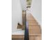 Modern staircase with wooden steps and black metal railing at 1760 Mondrian Cir, Winter Park, FL 32789