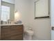 Modern bathroom features a sleek vanity with designer fixtures, a toilet, and a window for natural light at 1781 Pine Ave, Winter Park, FL 32789