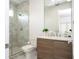 Modern bathroom featuring a marble-tiled shower and a wooden vanity with quartz countertop at 1781 Pine Ave, Winter Park, FL 32789