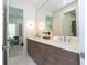 Bright bathroom featuring a double vanity with modern wood cabinets and quartz countertop with a large mirror at 1781 Pine Ave, Winter Park, FL 32789